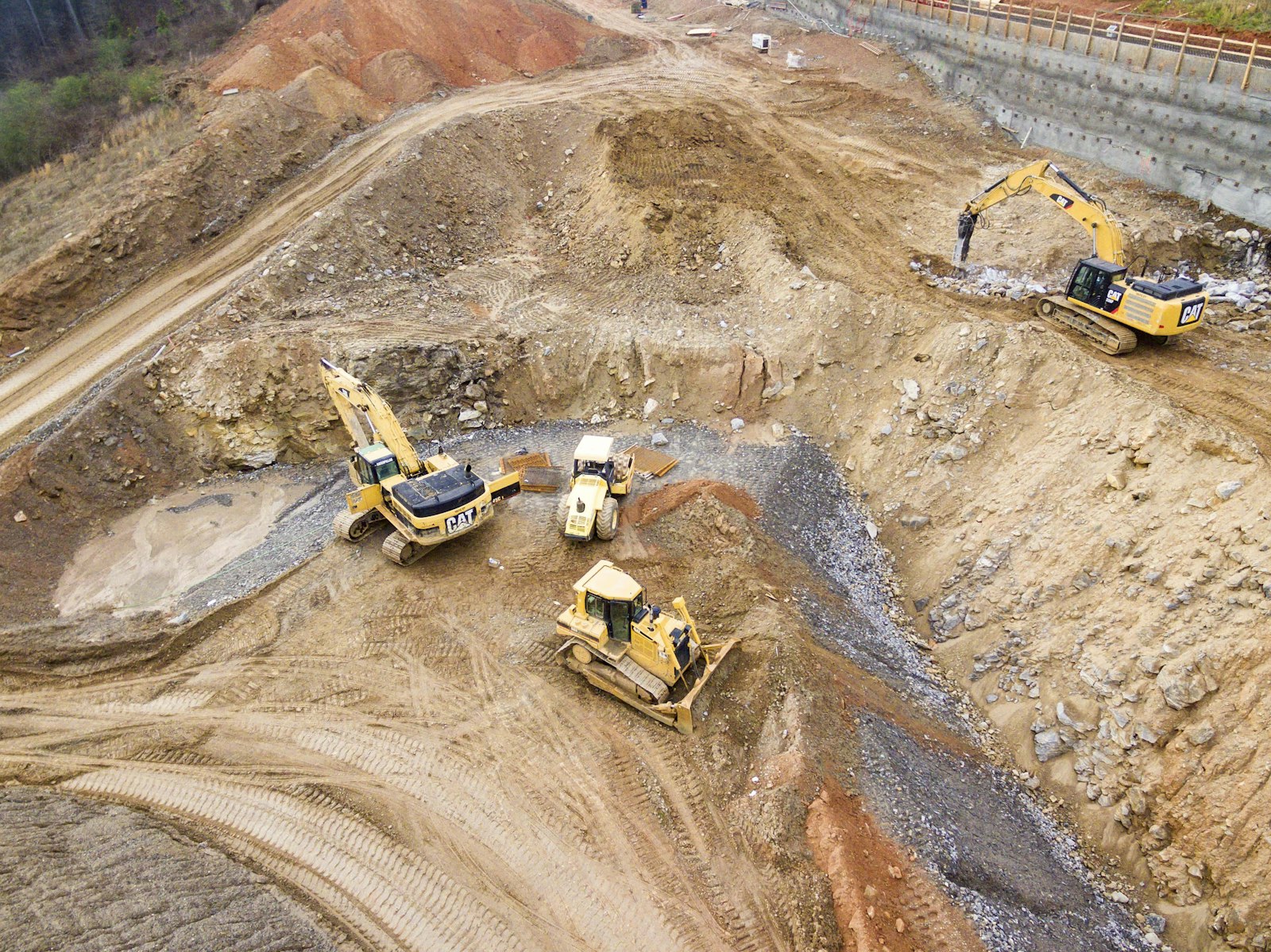 Excavators performing mass excavation on a dirt site