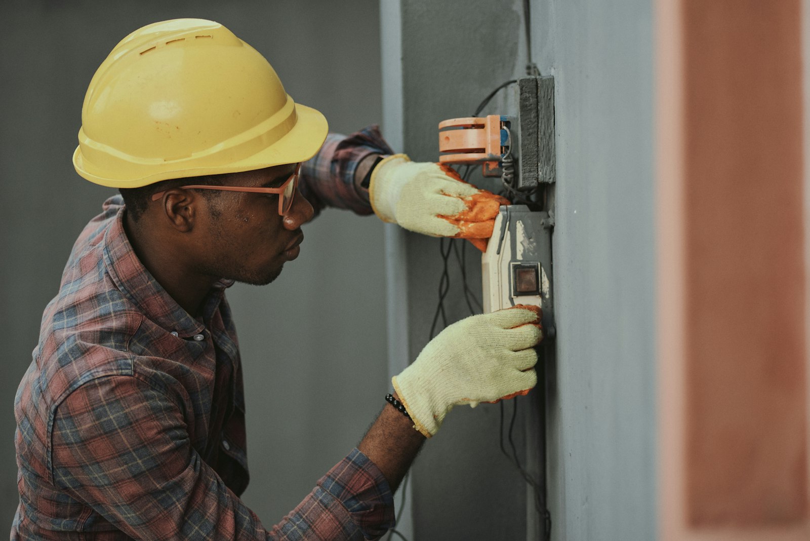 Utility work being performed by crew member in hard hat